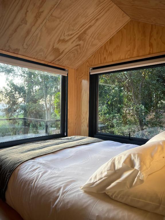 Postel nebo postele na pokoji v ubytování Cabaña en Santuario El Ajial - Paine - Tucu Cabins