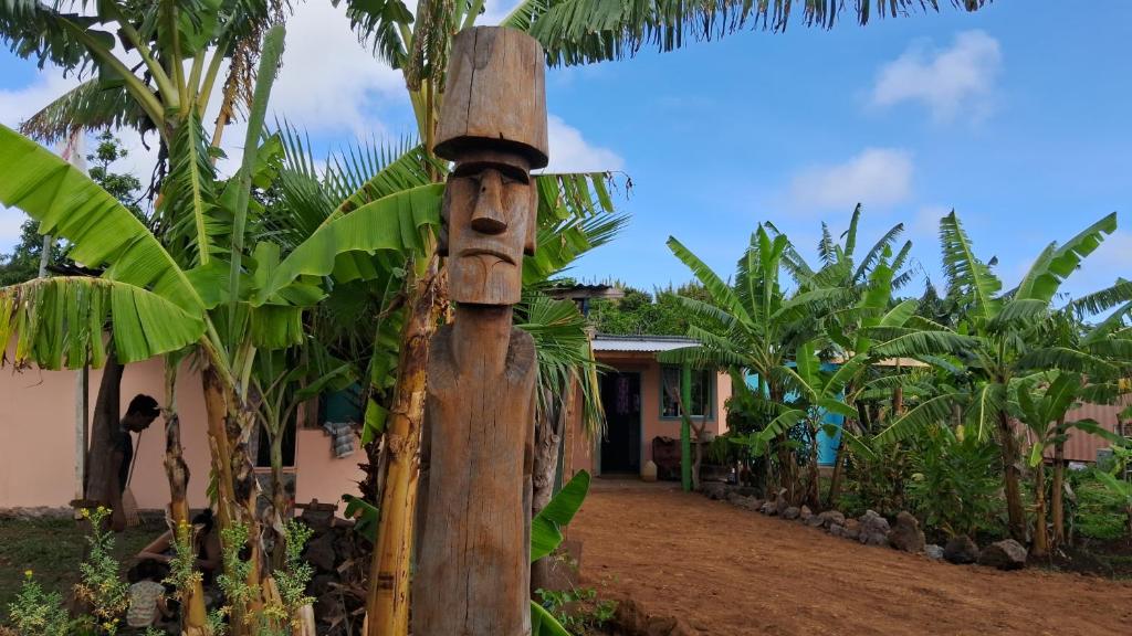 a wooden pole in front of a banana plantation at Rapa Nui Oficial in Hanga Roa