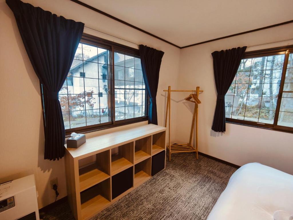 Postel nebo postele na pokoji v ubytování Hotel Foxtrot Hakuba