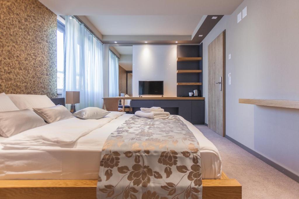 a bedroom with a large bed in a room at Plaza Hotel Winterthur in Winterthur