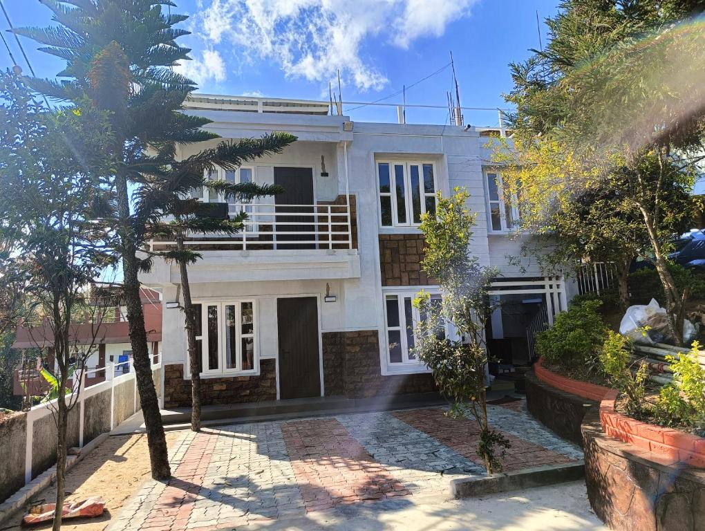 a house with a palm tree in front of it at Tersha Homestay 2BHK in Shillong