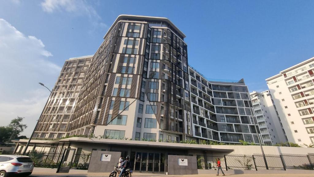 a tall building with people standing in front of it at Loxwood House by Cozy in Accra