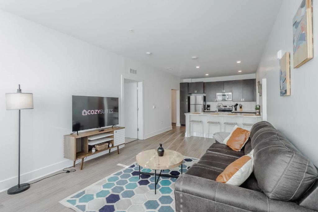 a living room with a couch and a table at Cozysuites l Luxe 2BR in Downtown Cincinnati #2 in Cincinnati