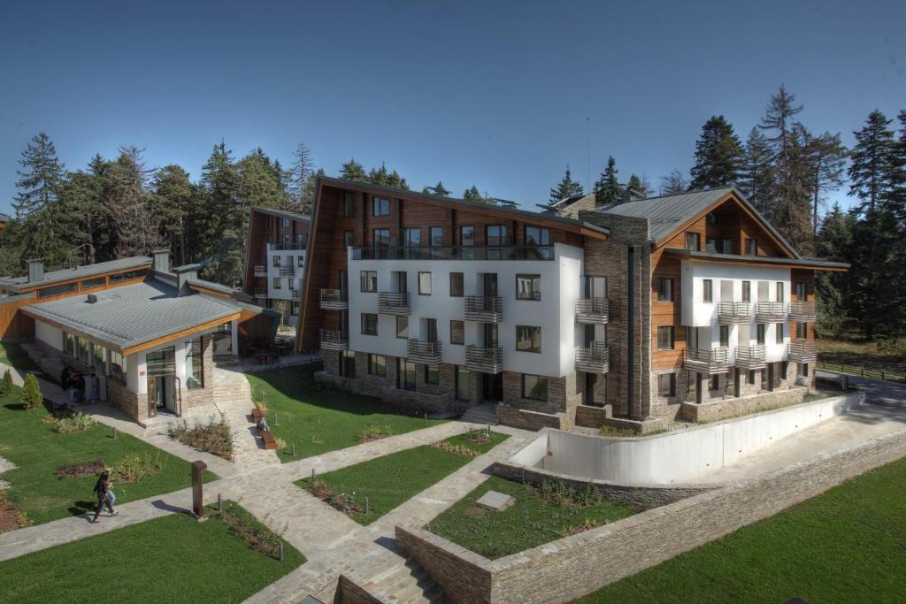 a large house with a large stone building on top of it at Euphoria Club Hotel in Borovets