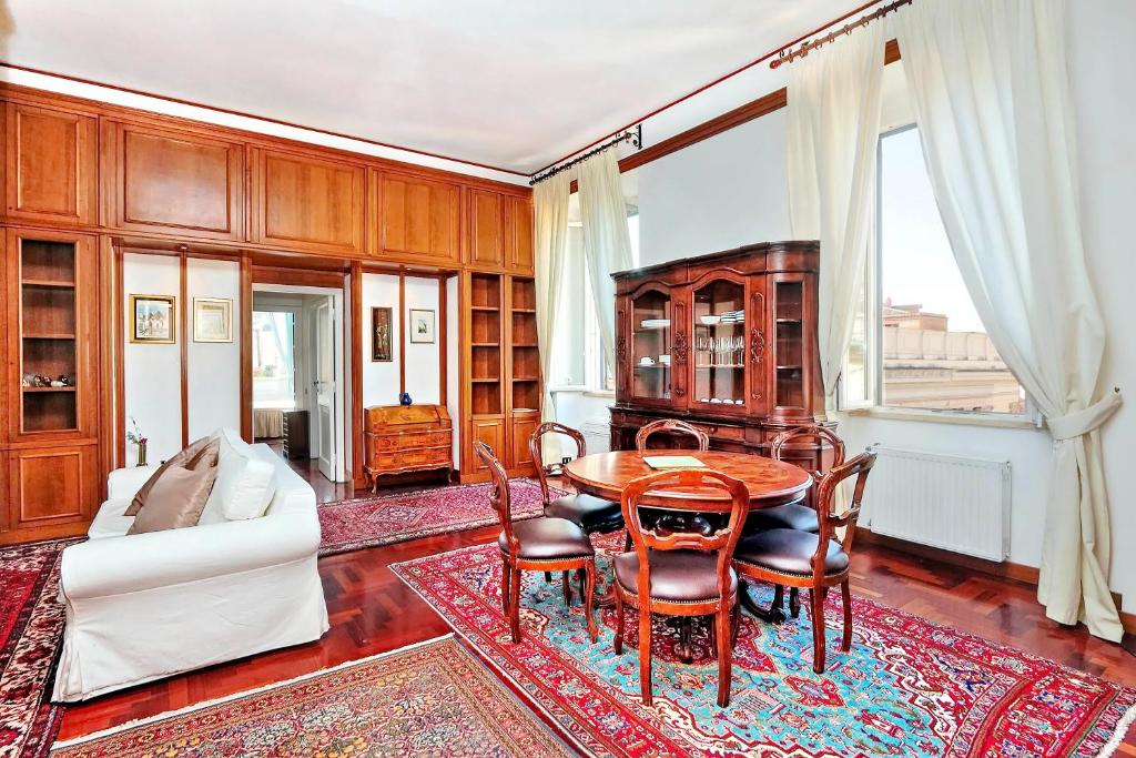 a living room with a table and a couch at Pantheon Family Romantic Suite in Rome