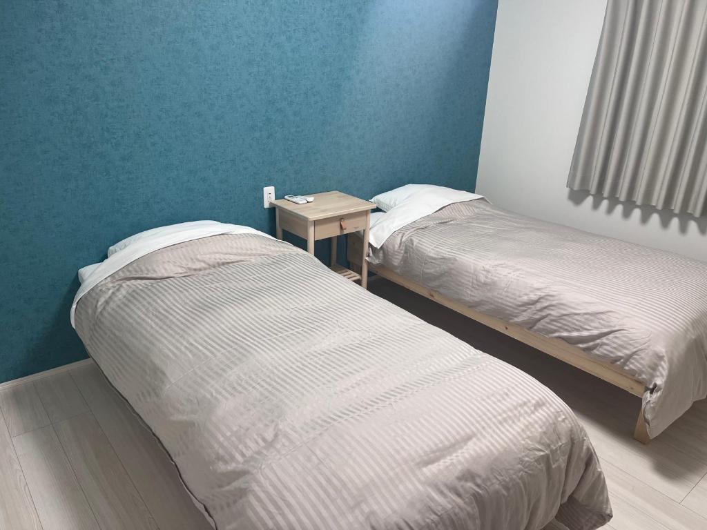Postel nebo postele na pokoji v ubytování GUNPAKUMaebashi