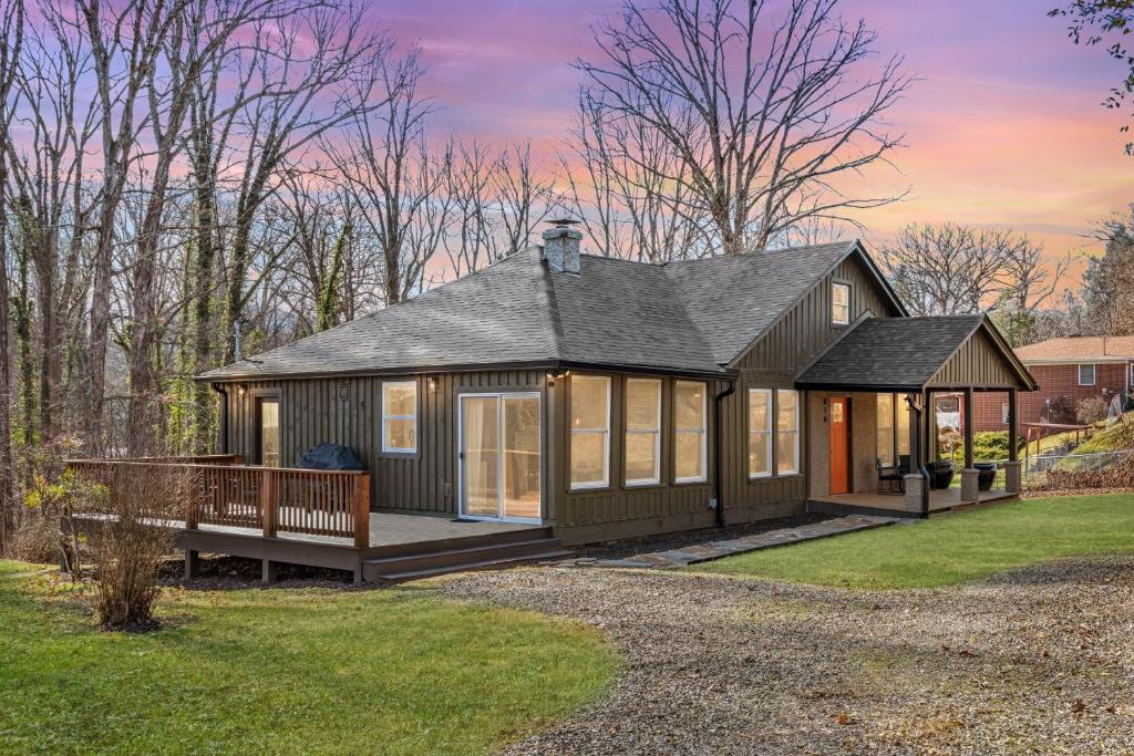 a tiny house with a porch and a deck at Sage Lodge by AvantStay 15 Min to Downtown Deck in Asheville