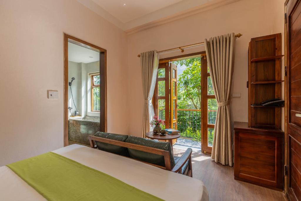 Postel nebo postele na pokoji v ubytování Sundara Retreat