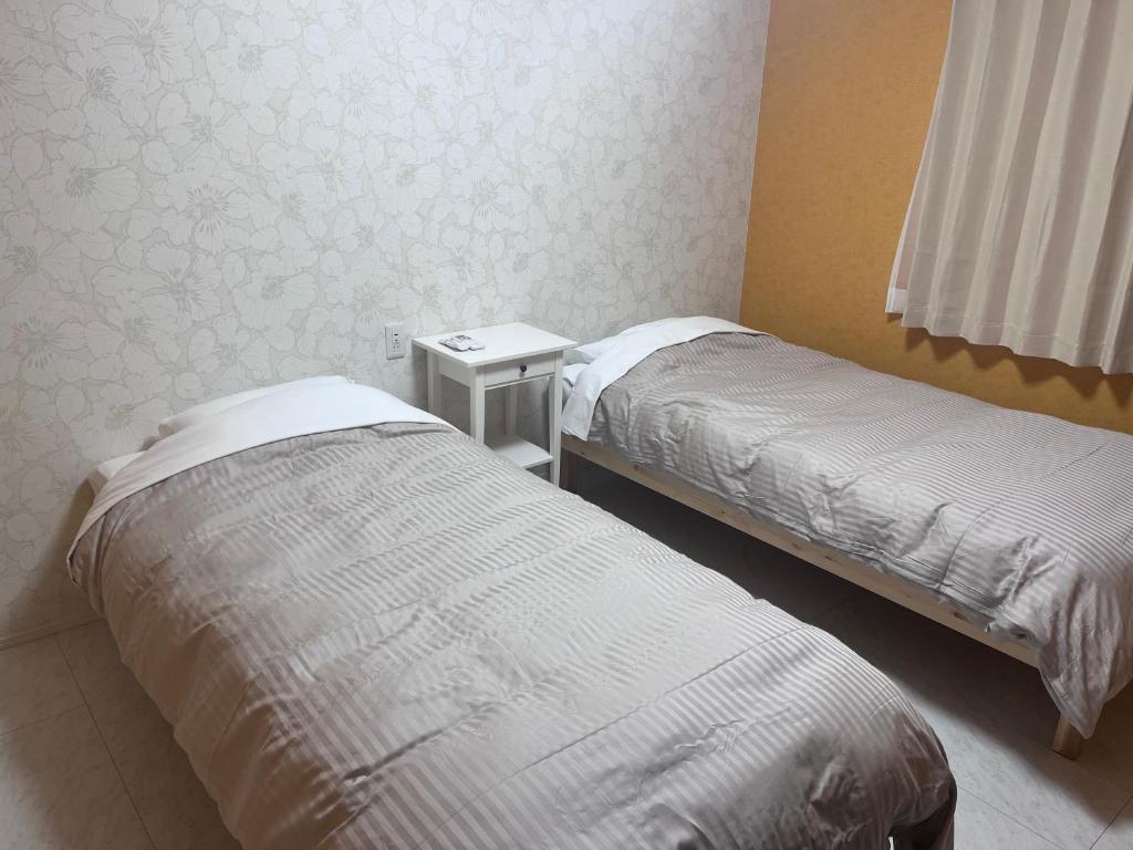 Postel nebo postele na pokoji v ubytování GUNPAKUMaebashi