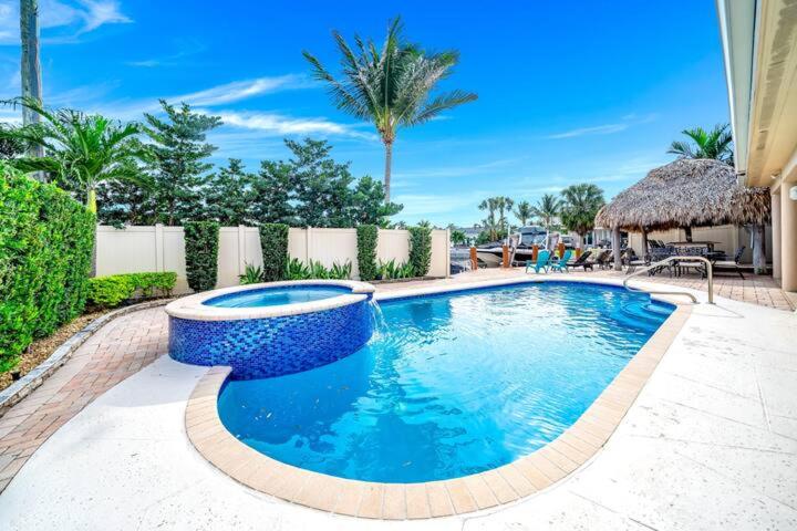 a swimming pool with a blue bowl in a yard at Luxury Water Front, Heated Pool & Jacuzzi, 5bdrm in Pompano Beach