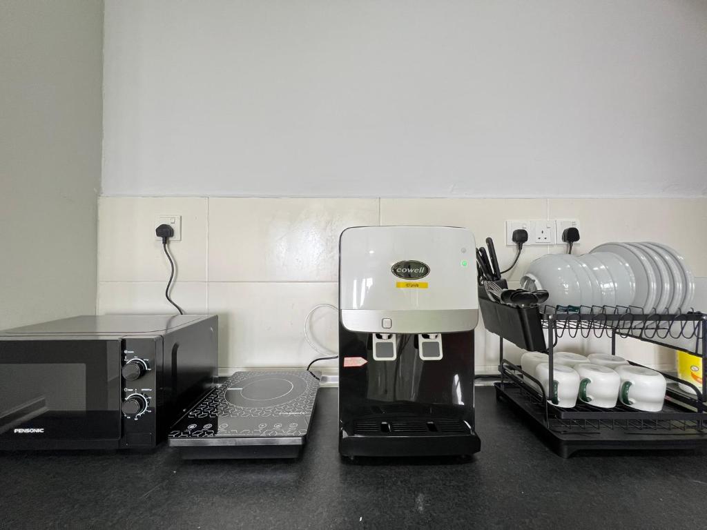 a coffee maker sitting on top of a kitchen counter at RiverView 8PAX 2BR in KBtown Wi-Fi, A-1-6 in Kota Bharu