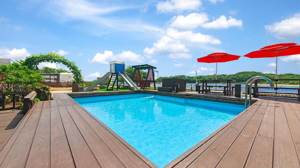 a swimming pool with a roller coaster and an amusement park at Daebudo Dekapo Pension in Ansan