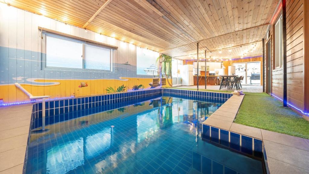 a large swimming pool in a house at Cheongdo Ellago Poolvilla Pension in Cheongdo