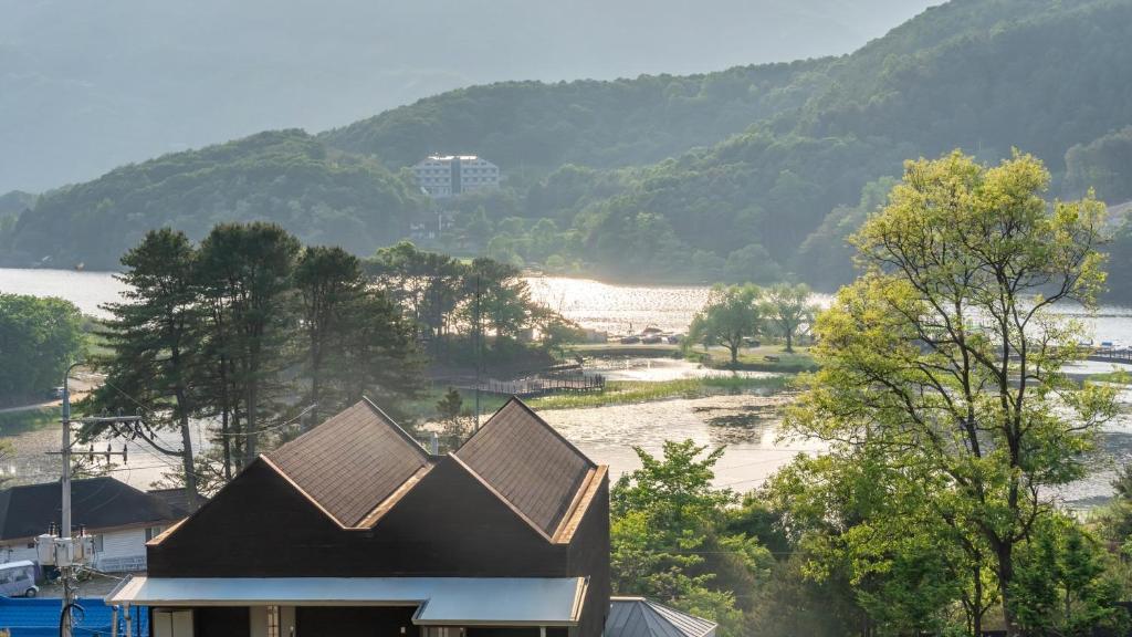 a house with a view of a body of water at Gapyeong Yeonkkocchosu Pet Pension in Gapyeong
