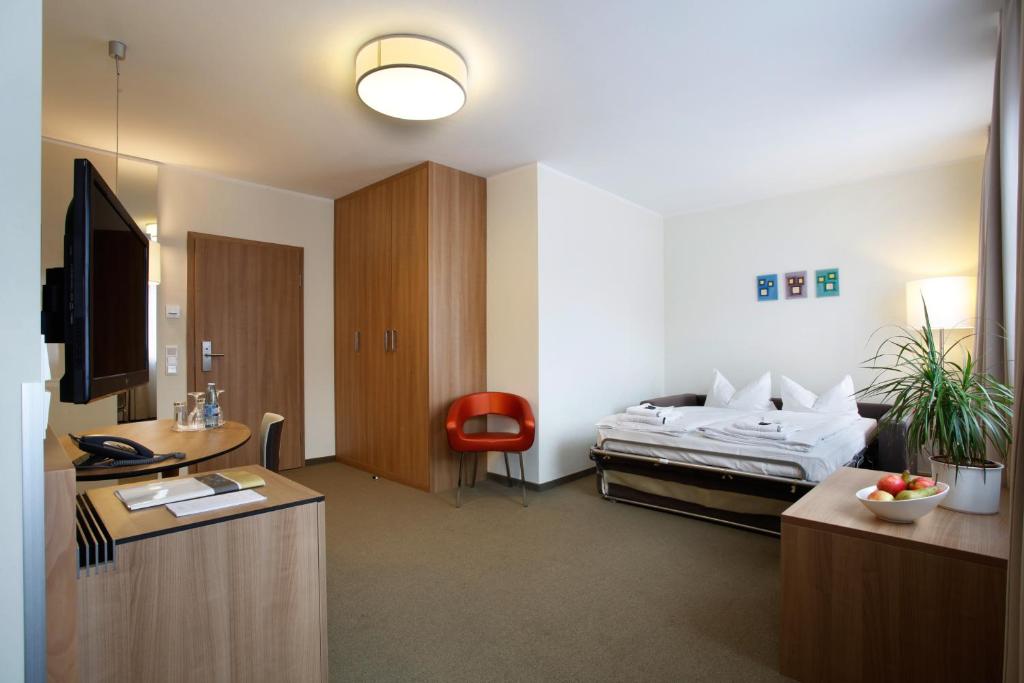 a hotel room with a bed and a desk at Hotel am Jakobsmarkt in Nuremberg