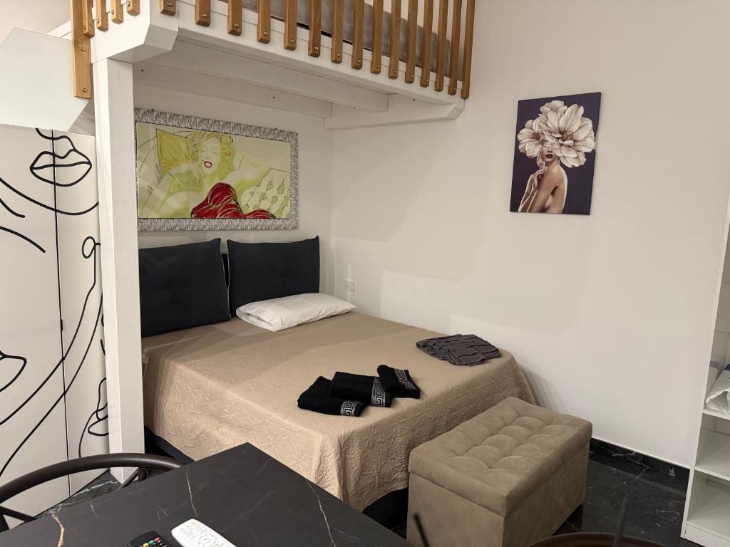 a small room with a bed and a chair at Suite Aurora in Crotone