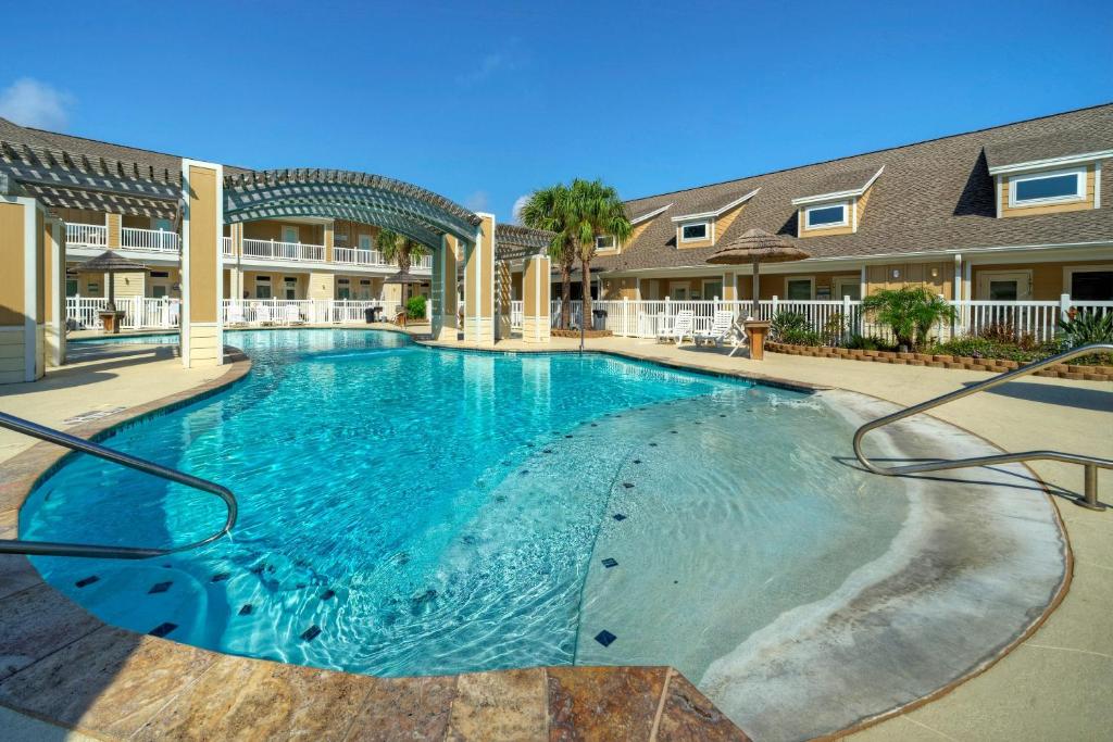a large swimming pool with blue water at The Beautiful Place by AvantStay Mins to Beach Family-Friendly Pool in Padre Island
