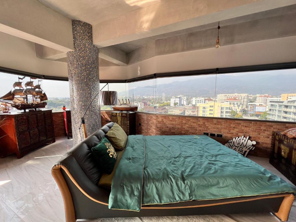 a bedroom with a bed and a large window at Luxury Apartment in Nimman, 5 mins to Maya in Chiang Mai