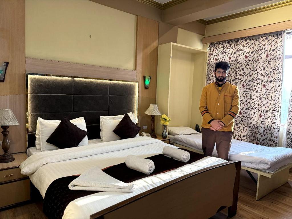 Postel nebo postele na pokoji v ubytování Hotel New Mamta