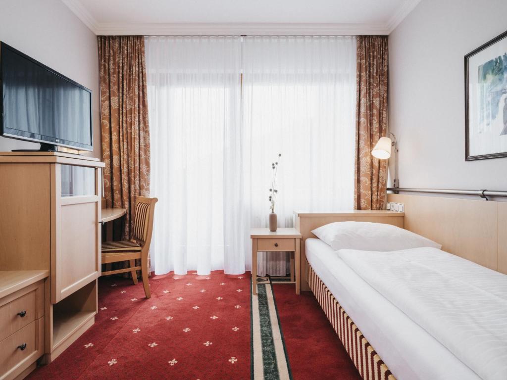 Postel nebo postele na pokoji v ubytování Sporthotel Royer