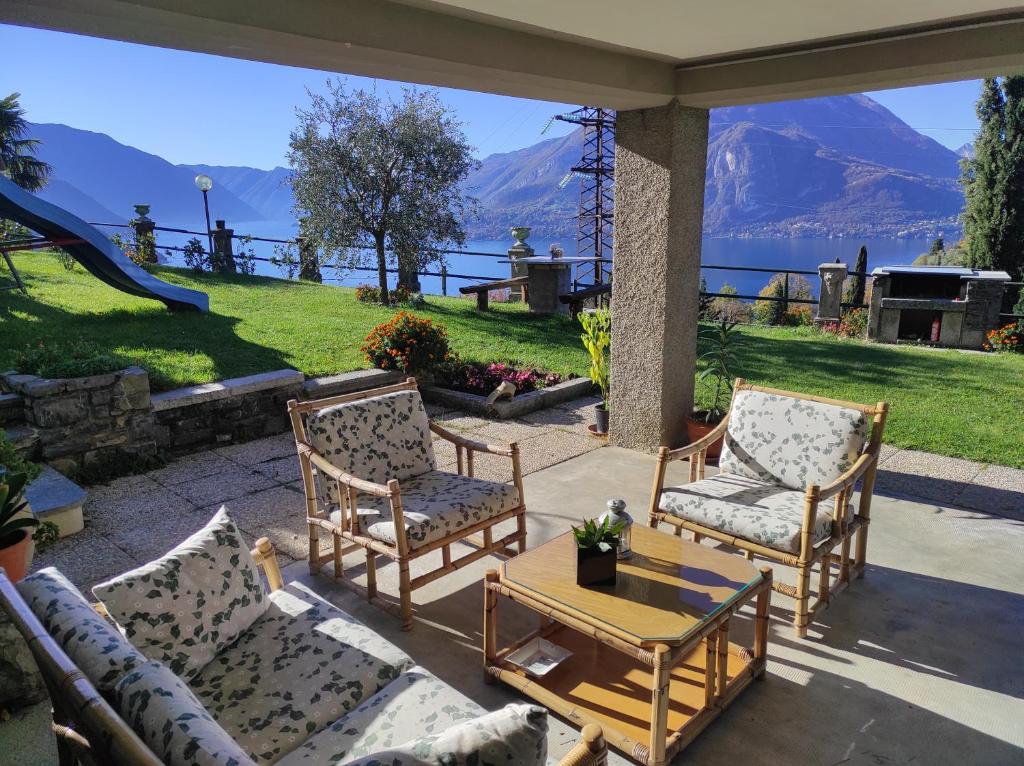 a patio with two chairs and a table with a view at Vezio Hill House in Perledo