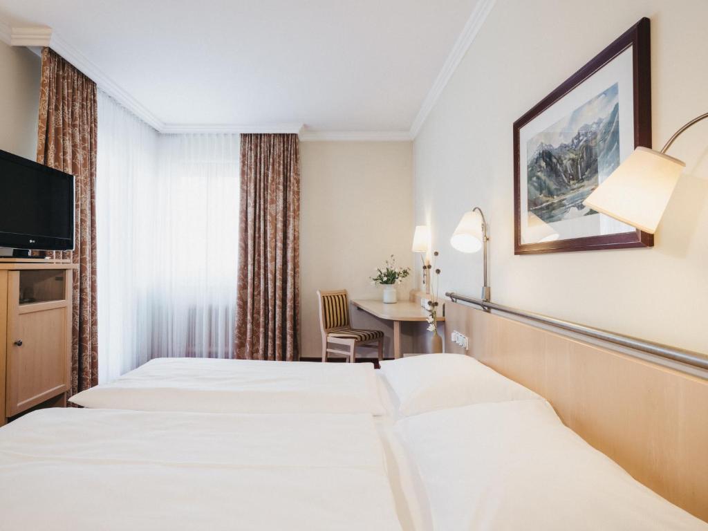 Postel nebo postele na pokoji v ubytování Sporthotel Royer