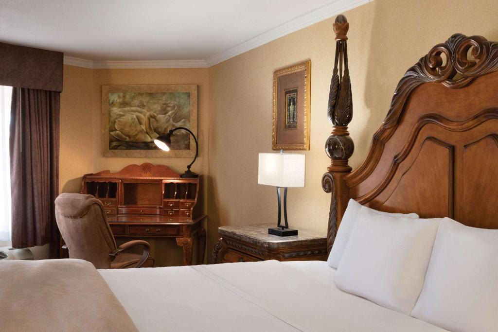 a hotel room with a bed and a desk at Radisson Hotel Colorado Springs Airport in Colorado Springs