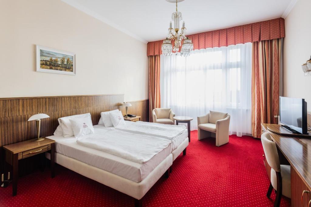 Postel nebo postele na pokoji v ubytování Royal Marianske Lazne