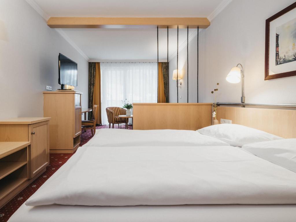 Postel nebo postele na pokoji v ubytování Sporthotel Royer
