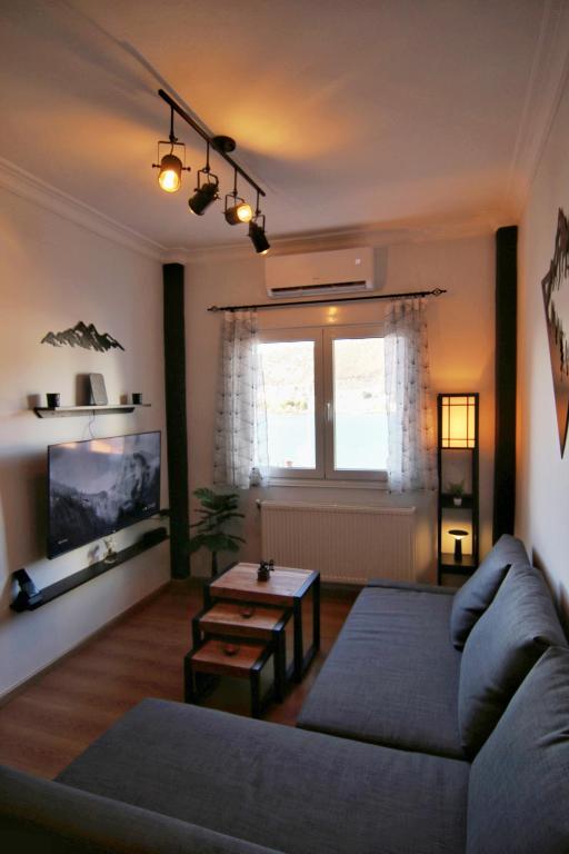 a living room with a couch and a table at Spitaki Kastoria Apartment in Kastoria