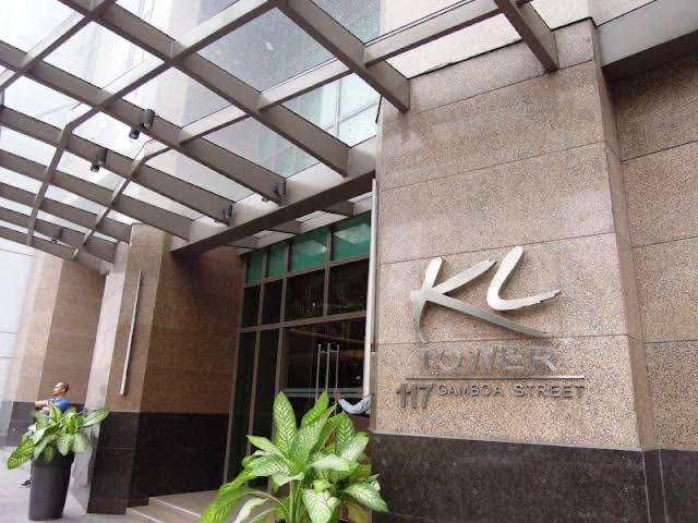 a building with a sign on the side of it at KL Rooms at Greenbelt makati with cityview in Manila