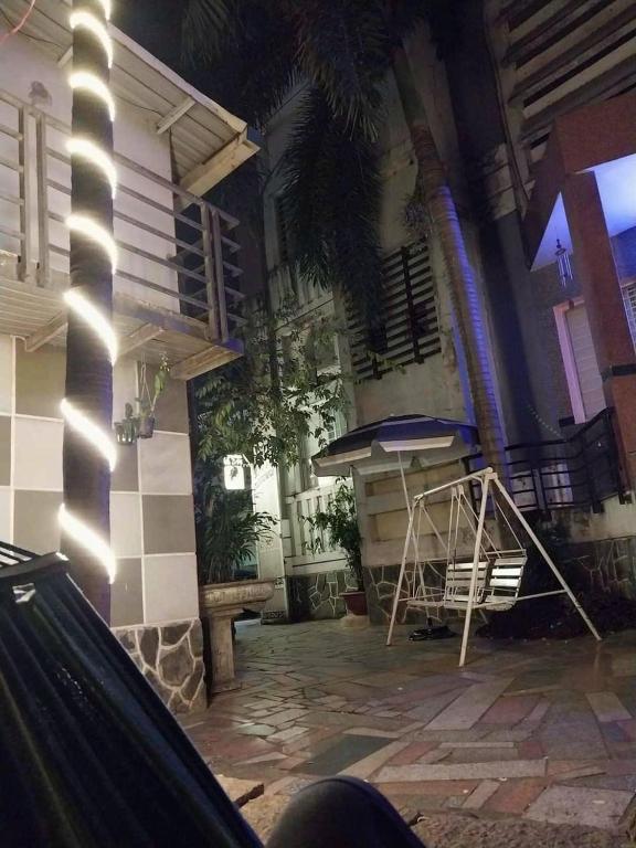 a patio with a table and a bench in front of a building at Khách Sạn Khánh Du - Khanh Du Hotel in Bien Hoa