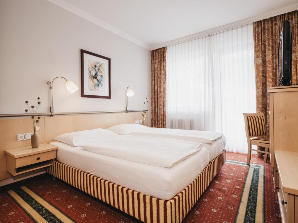 Postel nebo postele na pokoji v ubytování Sporthotel Royer