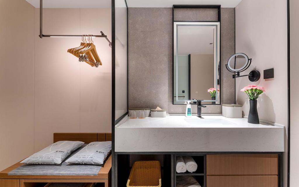 a bathroom with a sink and a mirror at Atour Hotel Kunming Tongde Plaza Beijing Road in Kunming