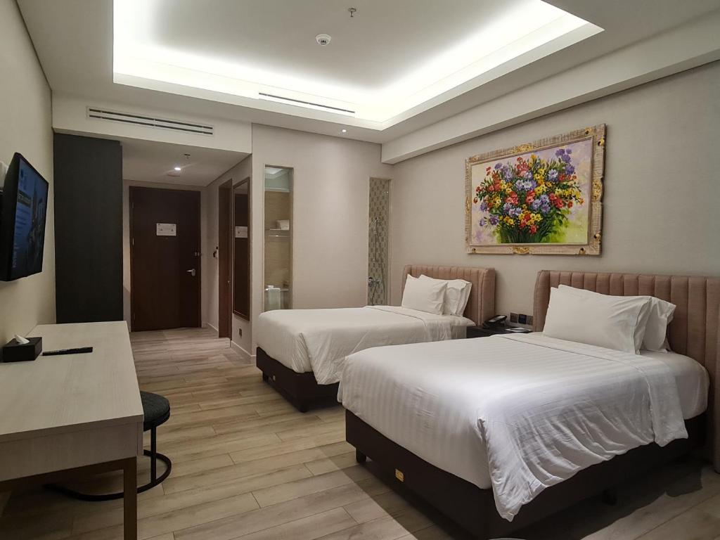 Ένα ή περισσότερα κρεβάτια σε δωμάτιο στο Trembesi Hotel