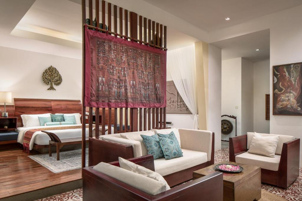 a living room with a bed and a couch at Lynnaya Urban River Resort in Siem Reap