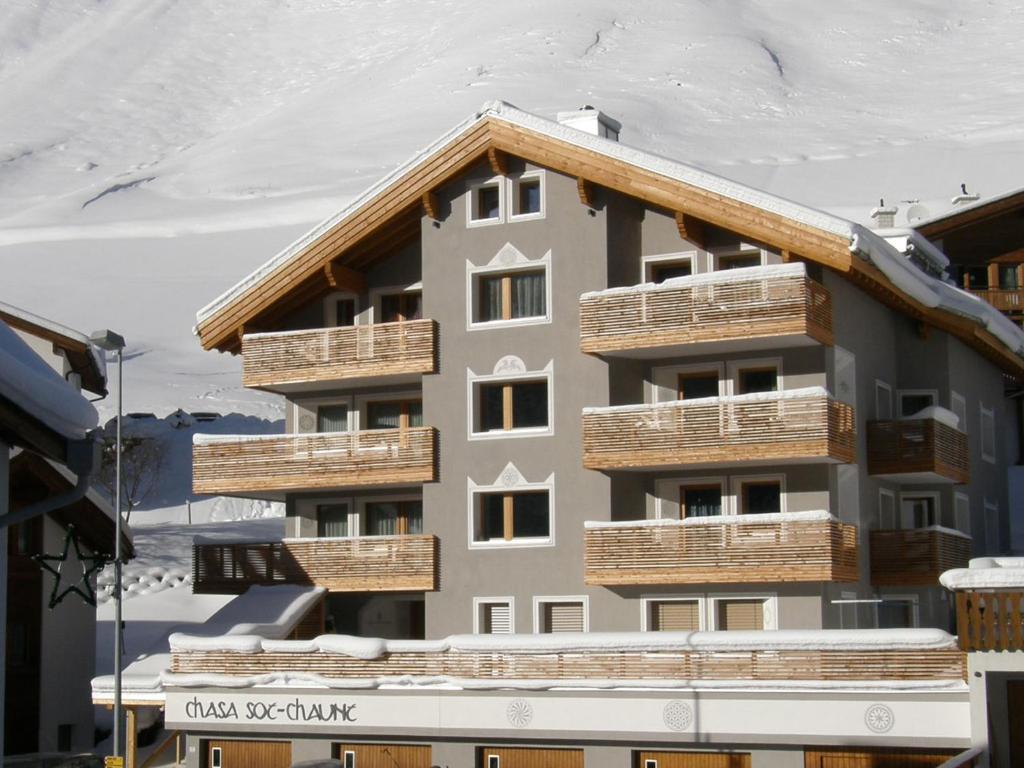 ein Gebäude mit Holzbalkonen auf der Seite in der Unterkunft Chasa Sot-Chaunt in Samnaun