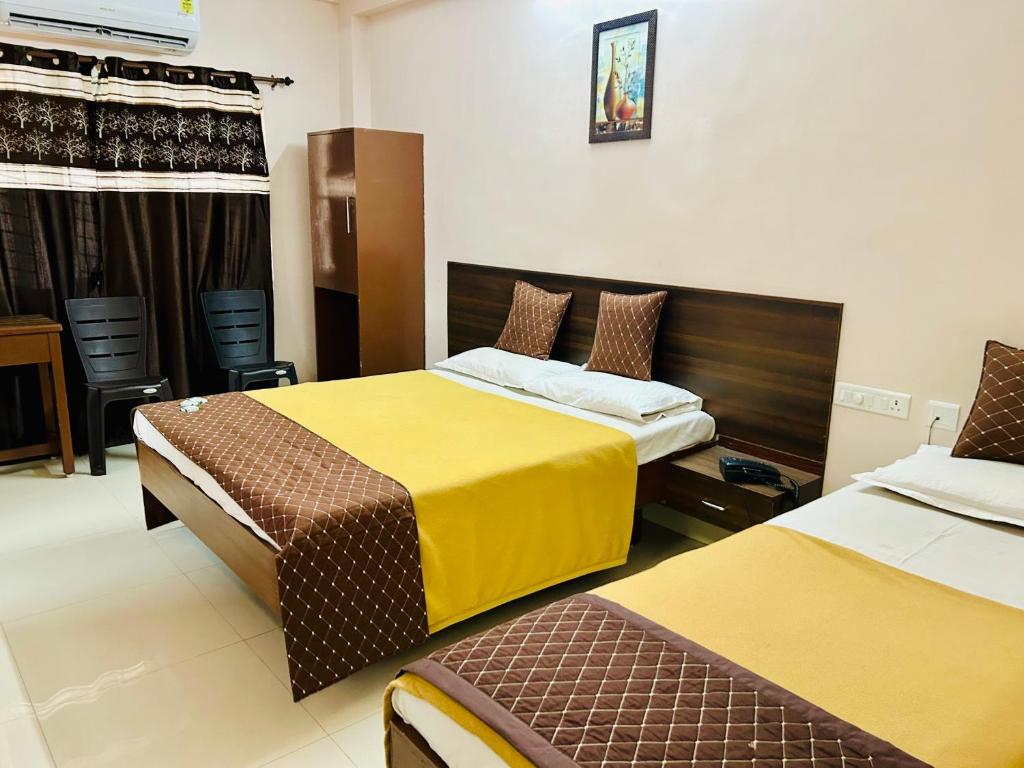 Postel nebo postele na pokoji v ubytování Hotel Jothi
