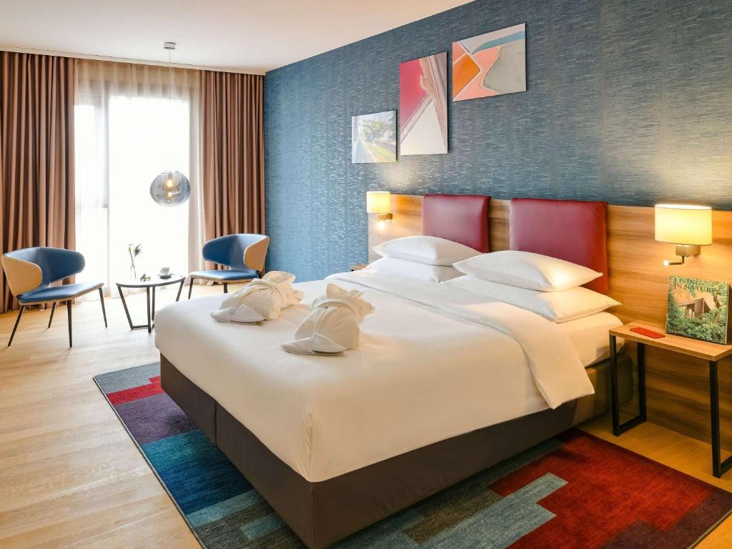 Postel nebo postele na pokoji v ubytování Mercure Geneva Airport