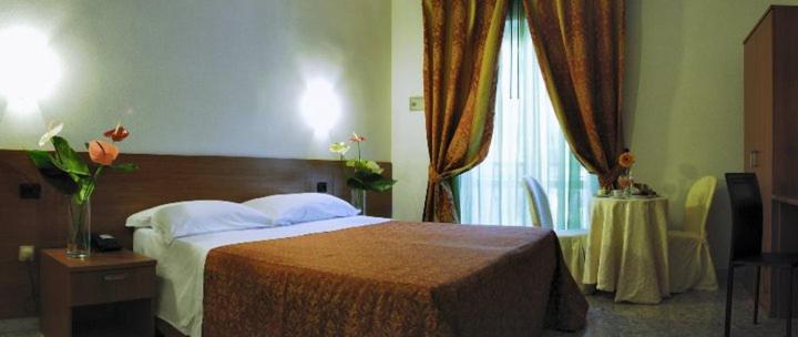 Postel nebo postele na pokoji v ubytování Hotel Villa Giusy