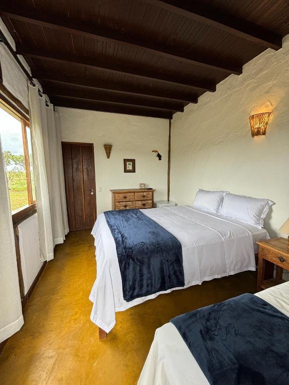 Postel nebo postele na pokoji v ubytování Cachoeira e Pousada Paraíso dos Pândavas