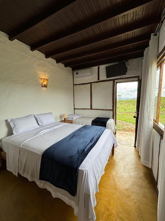 Postel nebo postele na pokoji v ubytování Cachoeira e Pousada Paraíso dos Pândavas