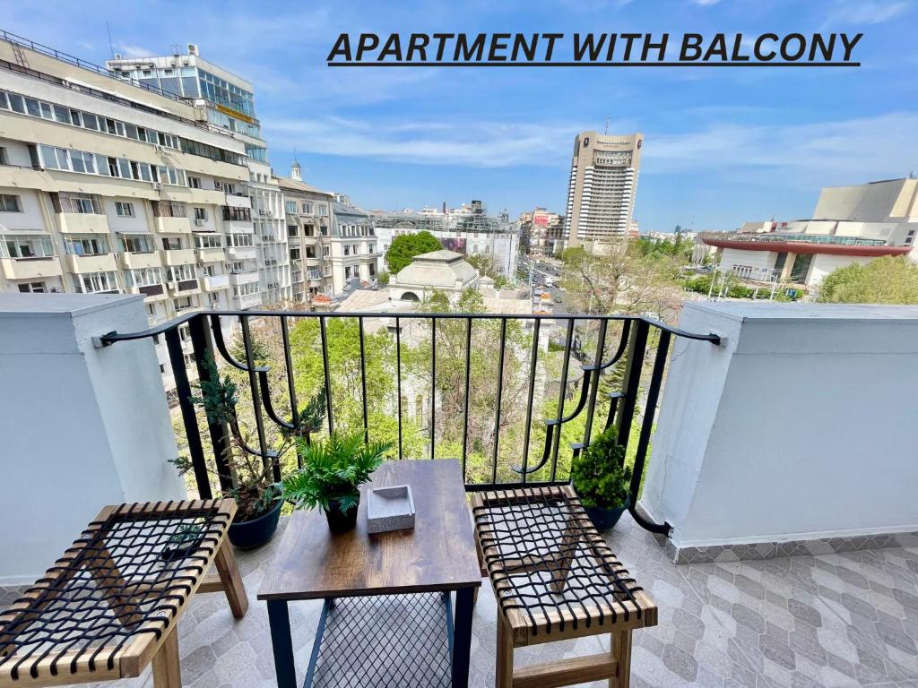 a balcony with two chairs and a table on a balcony at Metropole Apartments - Old City in Bucharest