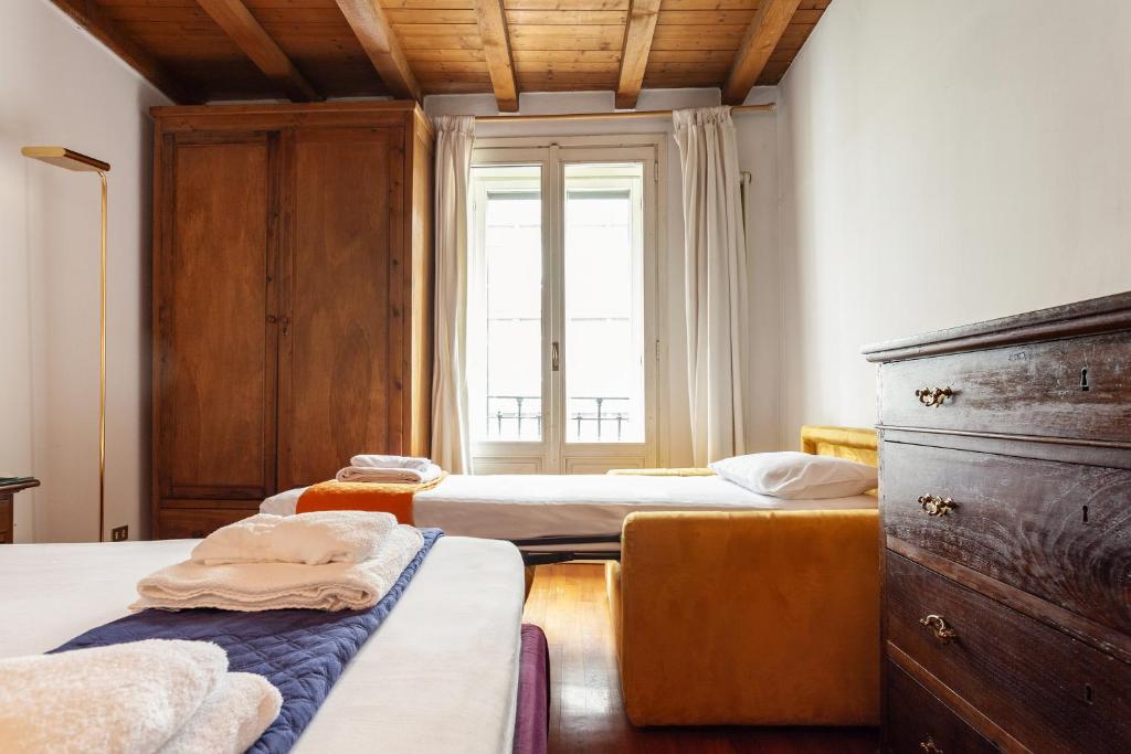 Łóżko lub łóżka w pokoju w obiekcie Suite Via Torino