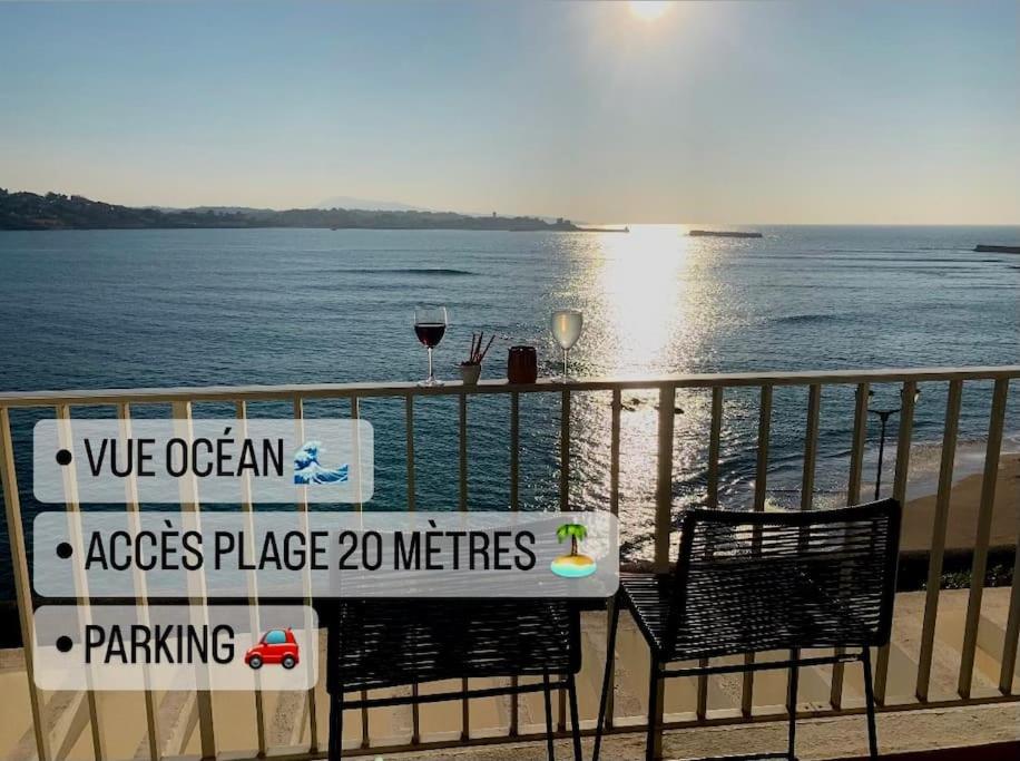 d'une table et de deux chaises sur un balcon donnant sur l'océan. dans l'établissement Les Pieds dans l eau, à Saint-Jean-de-Luz