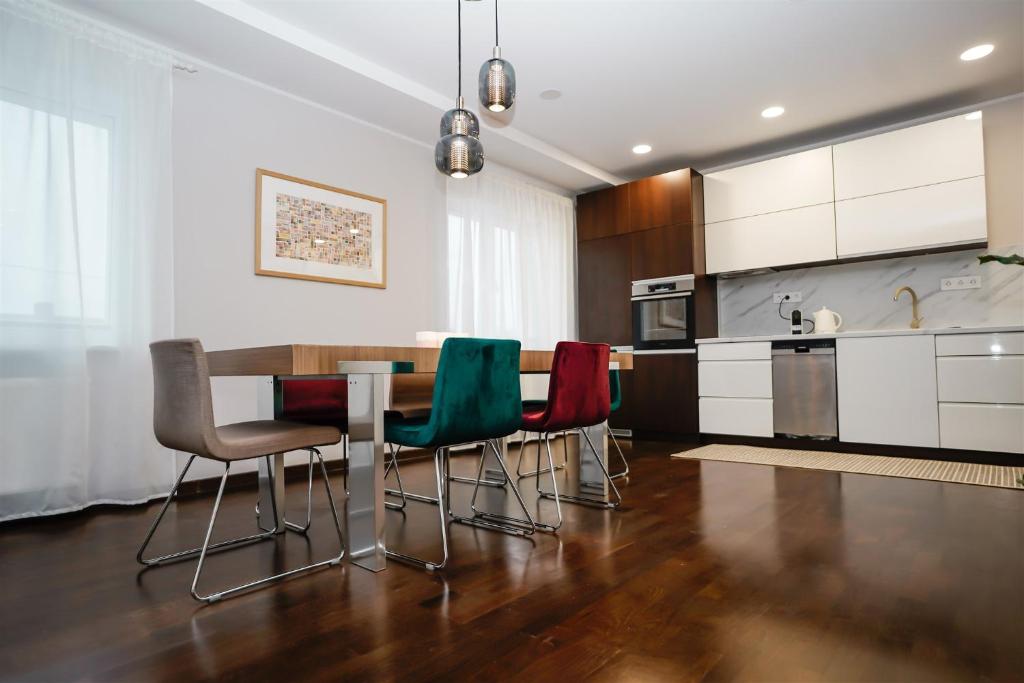 a kitchen with a table and four chairs at Garden Cottage in Šiauliai