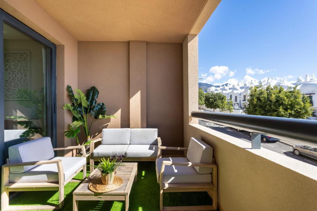 a balcony with chairs and a table and a view at Gorgeous Paraiso FREE WIFI in Playa Paraiso