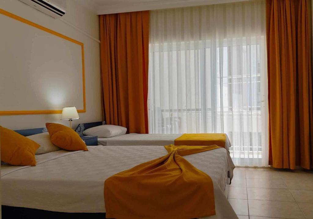 Postel nebo postele na pokoji v ubytování Yazıcı Otel Bozburun