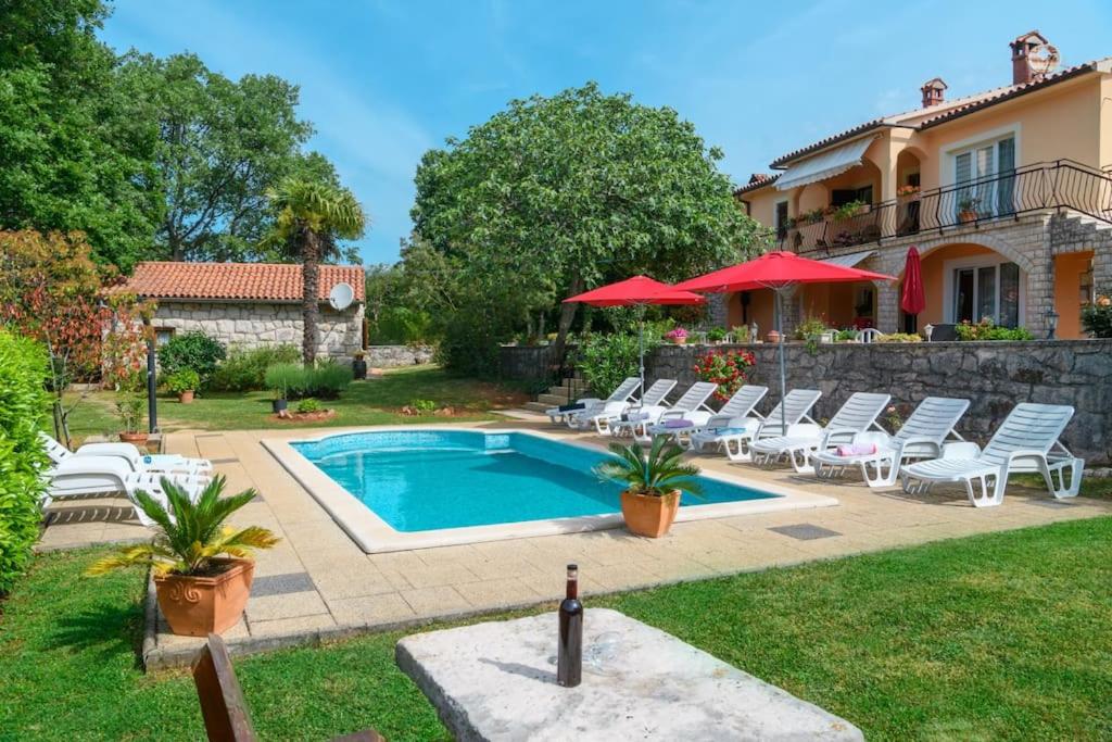 a swimming pool in a yard with chairs and a house at Casa Martina by Briskva in Šumber