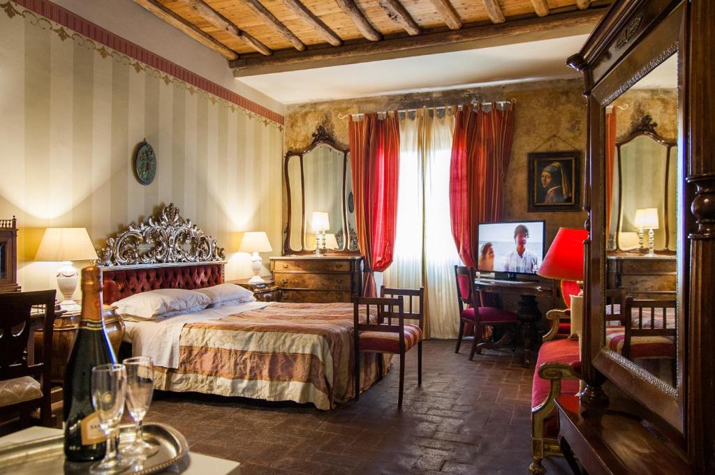 a bedroom with a bed and a desk and a piano at Al Tuscany B&B in Lucca